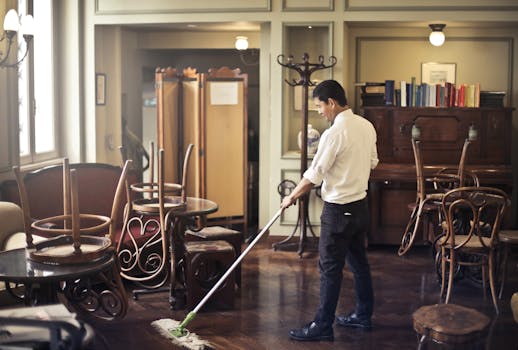 Janitor cleaning floor in restaurant